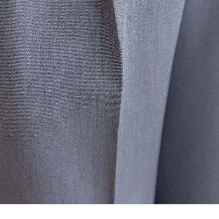 Close-up of high waist business trousers fabric showcasing fine texture.