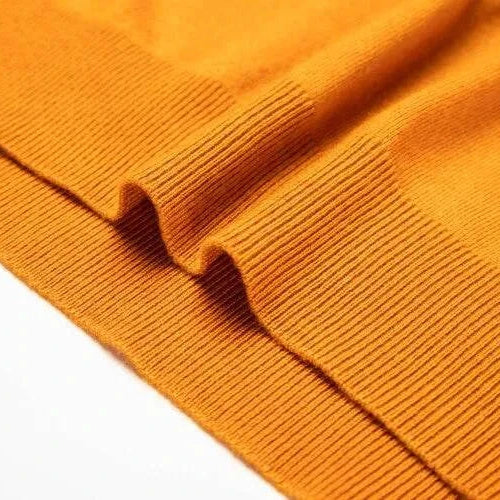 Close-up of yellow Antonios business polo premium sweater fabric detailing.
