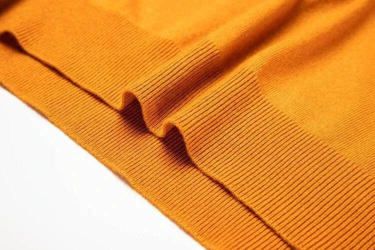 Close-up of yellow Antonios business polo premium sweater fabric detailing.