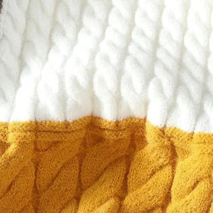 Norway neck sweater with textured knit pattern in brown, white, and yellow.