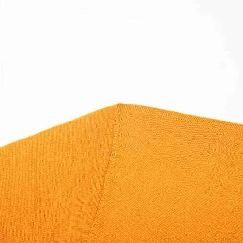 Close-up of orange fabric texture from Antonios Business Polo Premium Sweater.