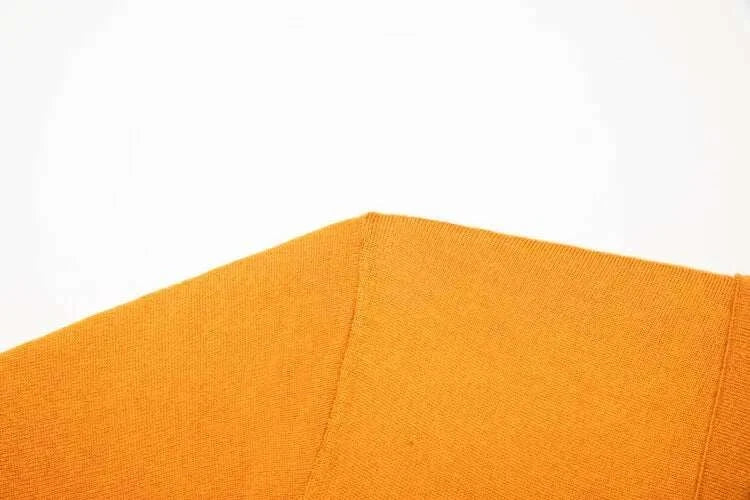 Close-up of orange fabric texture from Antonios Business Polo Premium Sweater.