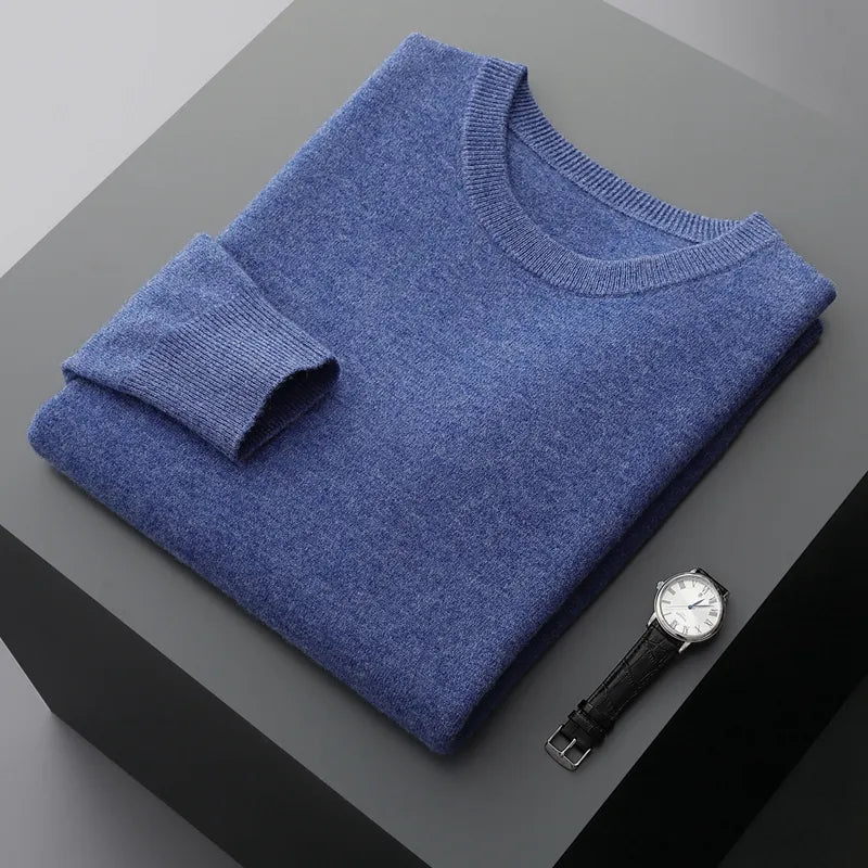 Antonios Pure Wool Sweater in blue, folded on display next to a watch.