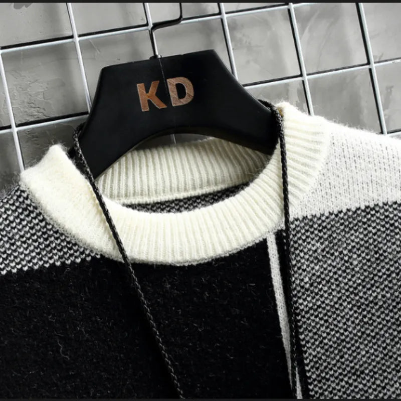 Norway sweater hanging on a black hanger against a tiled background.