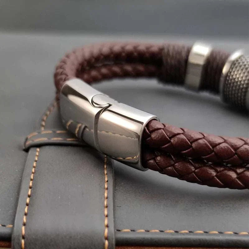 Genuine leather double bracelet with stainless steel clasp on leather surface.