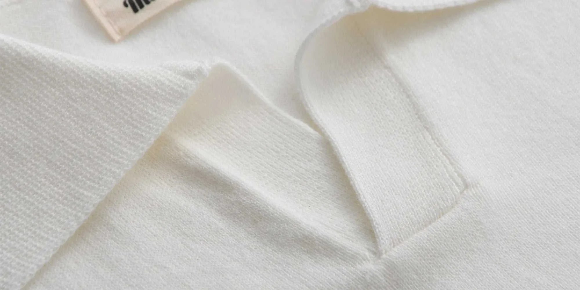 Old money American polo t-shirt in cotton, close-up of collar, white fabric.