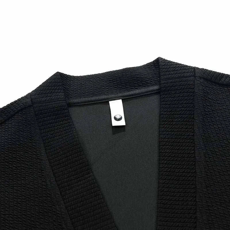 Black winter cardigan sweater with zipper, polyester and spandex blend, close-up.