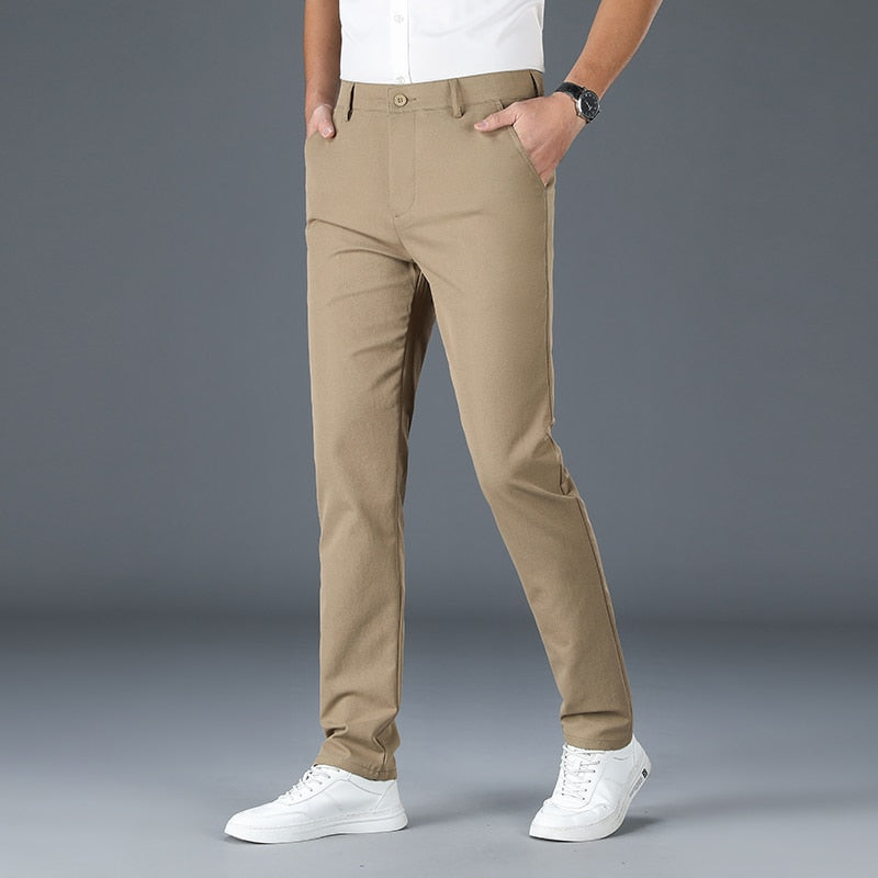 Man wearing khaki Antonios Stretch Pants with white sneakers.