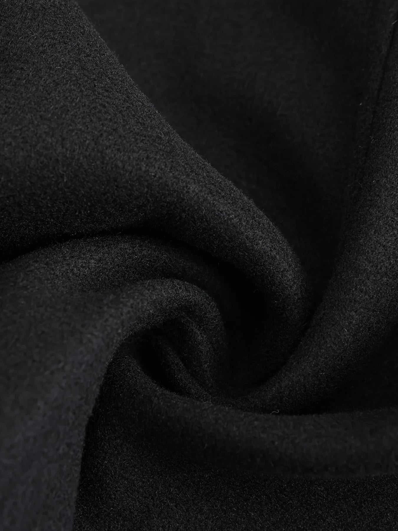 Close-up of black polyester fabric for a casual British long coat.