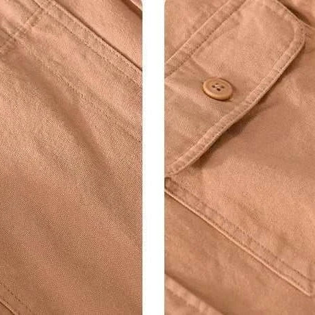 Close-up of premium short sleeve summer shirt fabric and button detail.