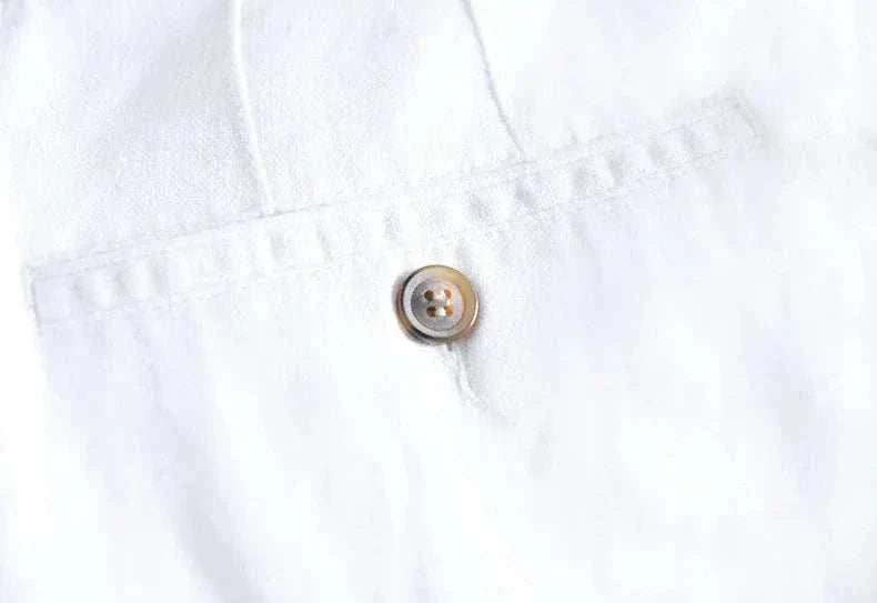 White straight oversize trousers with button detail.