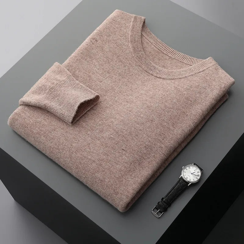 Antonios Pure Wool Sweater in beige, folded on a display with a watch.