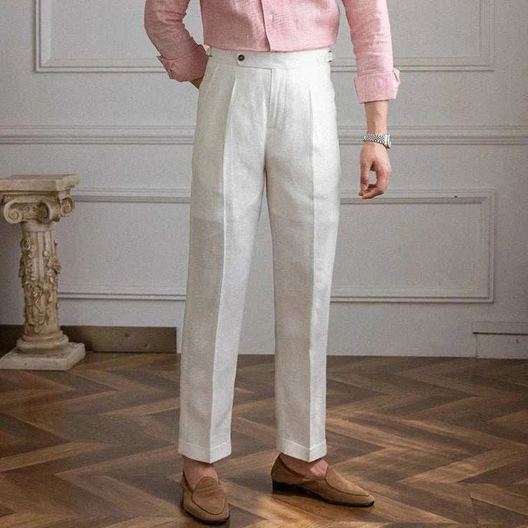 Lightweight Italian high-waist trousers in white linen, styled for casual elegance.