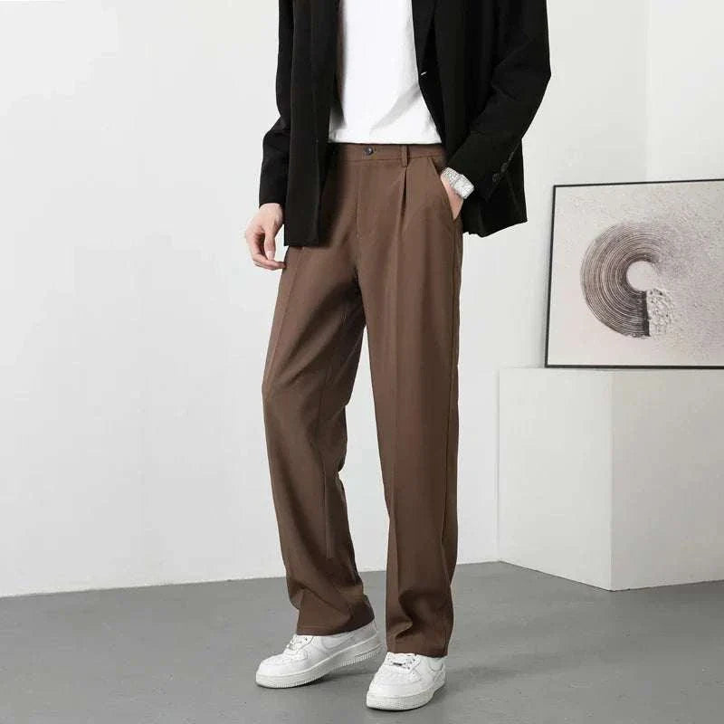 Korean chino pants in brown, styled with white sneakers and black blazer.