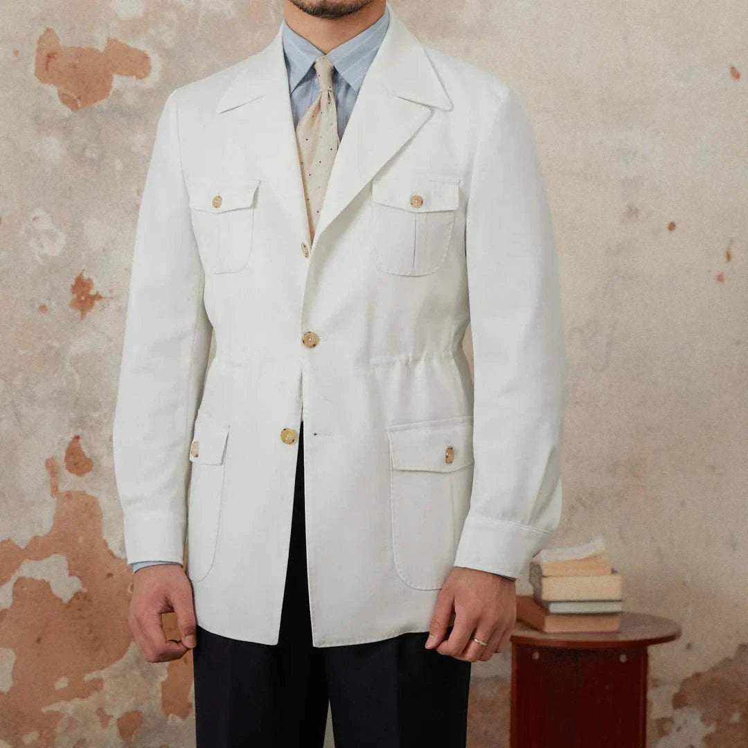 Man wearing Autumn vintage old money coat in white, standing against a textured background.