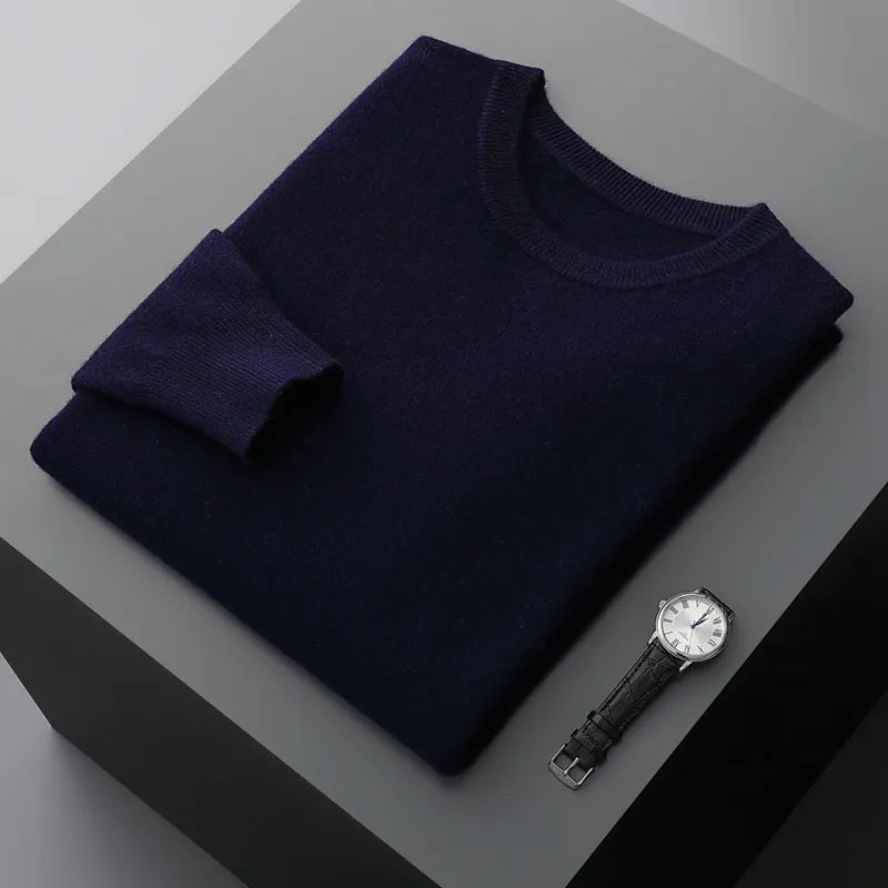 Antonios Pure Wool Sweater in solid Flower Blue, elegantly styled for men, with a watch on a table.