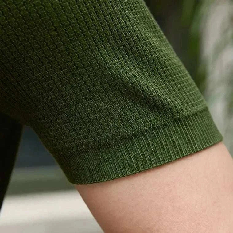 Close-up view of the sleeve detail on a Summer v-neck polo English t-shirt in solid green cotton fabric.