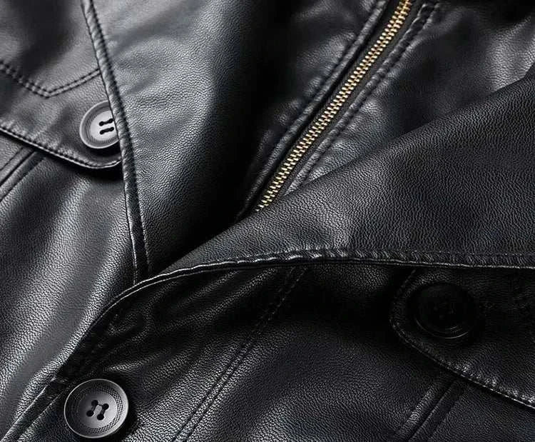 Close-up of black PU leather long coat with buttons and zipper.