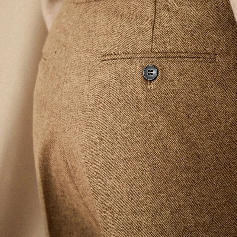 Close-up of wool winter Italian trousers with button detail, showcasing luxurious fabric.
