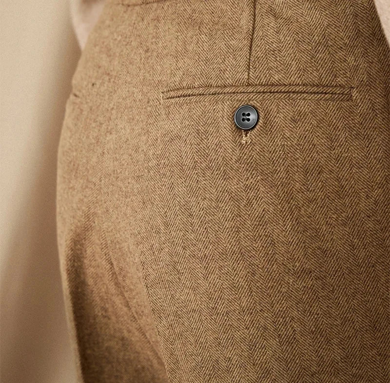 Close-up of wool winter Italian trousers with button detail, showcasing luxurious fabric.