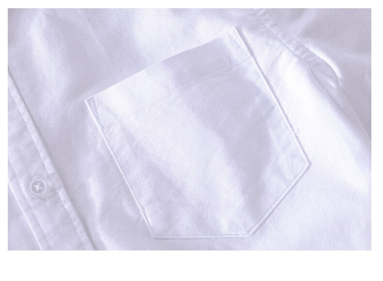 White cotton long sleeve shirt with front pocket detail.