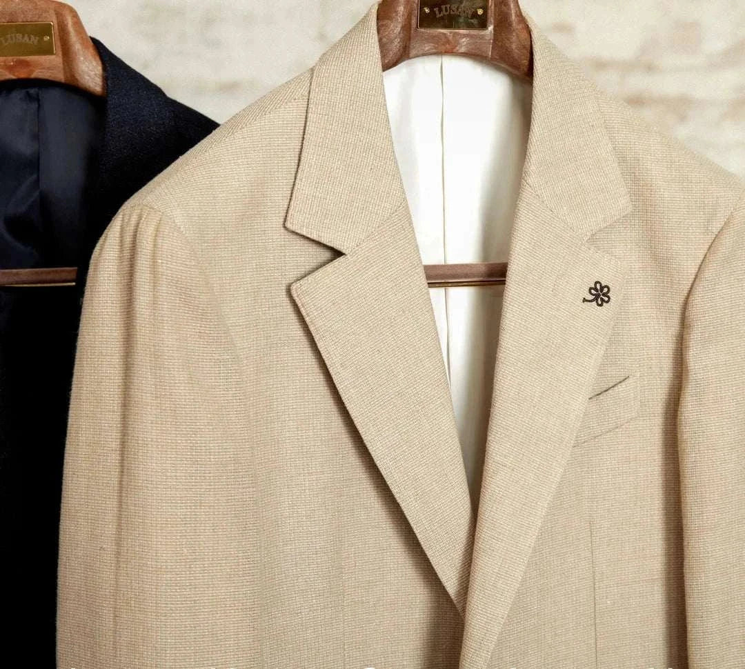 Slim fit cotton-linen blend jacket on wooden hanger.
