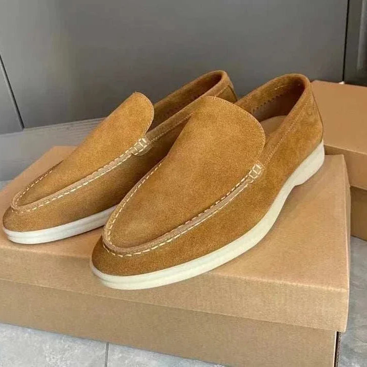 Suede elegant loafers made of soft sheep leather on display.