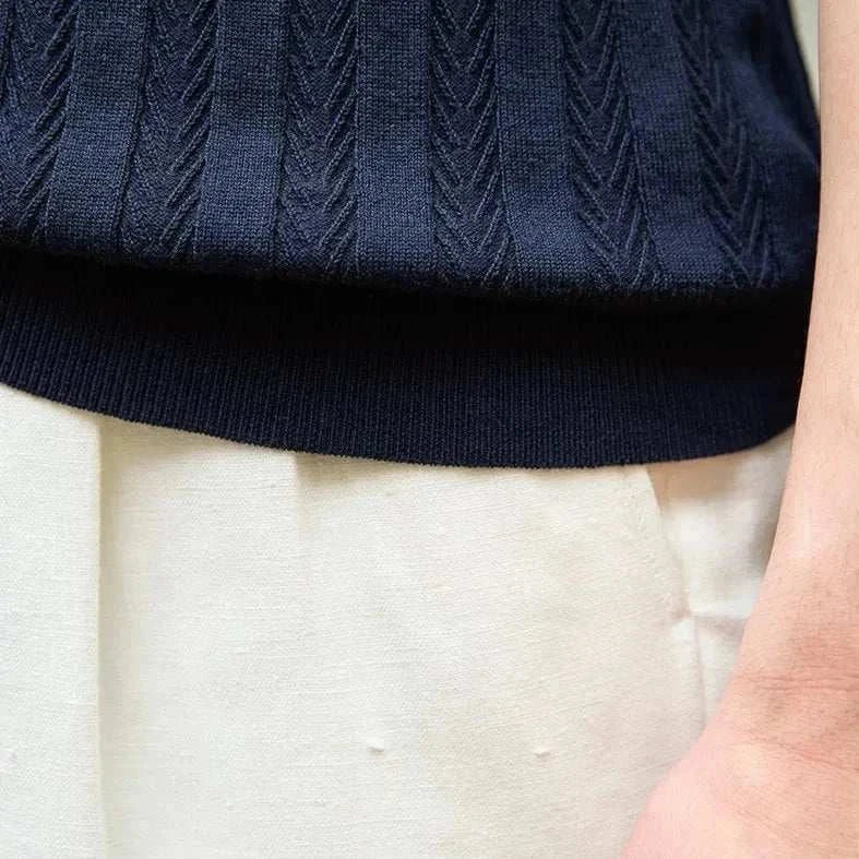 Close-up of navy textured fabric on Spring gentleman English t-shirt for men.