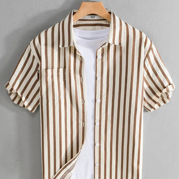 Striped printed shirt with short sleeves and casual fit on hanger.