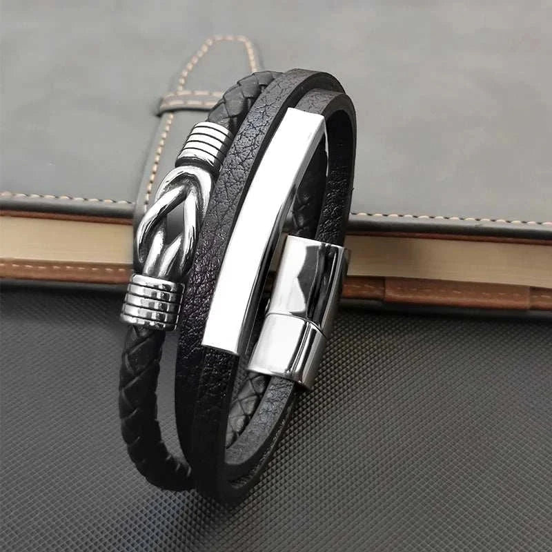 Triple layer leather bracelet with stainless steel accents and PU material.