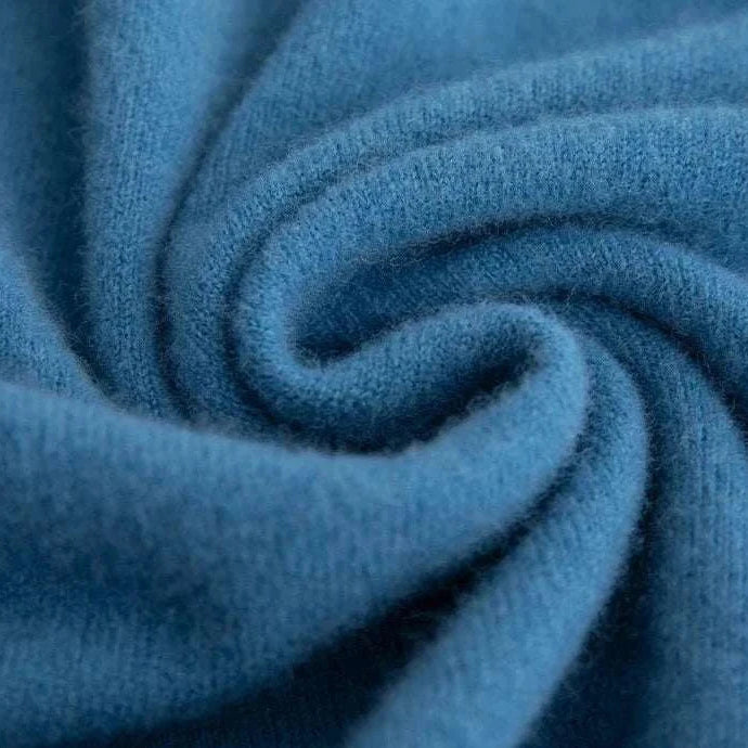 Close-up of soft blue business wool turtleneck sweater fabric.