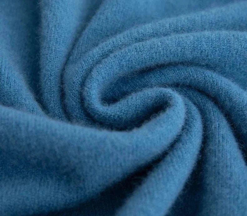 Close-up of soft blue business wool turtleneck sweater fabric.