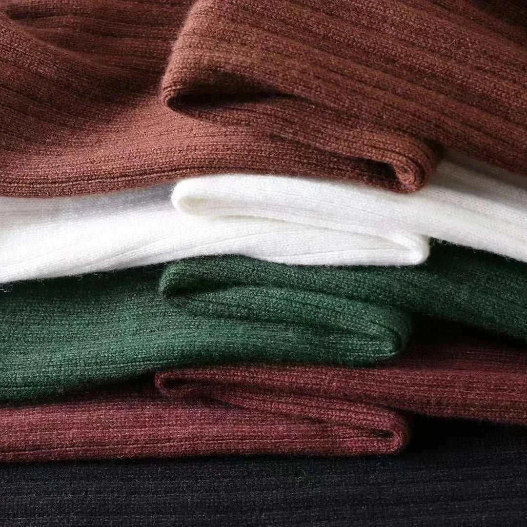 Stack of Antonios striped jacquard knit sweater in various colors, showcasing texture and softness.