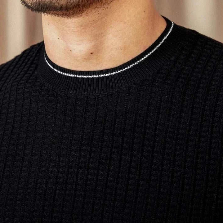 Winter wool sweater for men in black, close-up of textured fabric and neckline.
