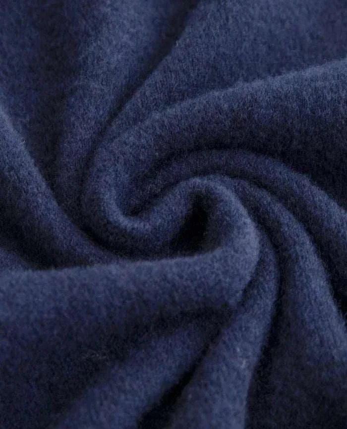 Close-up of navy blue business wool turtleneck sweater fabric.