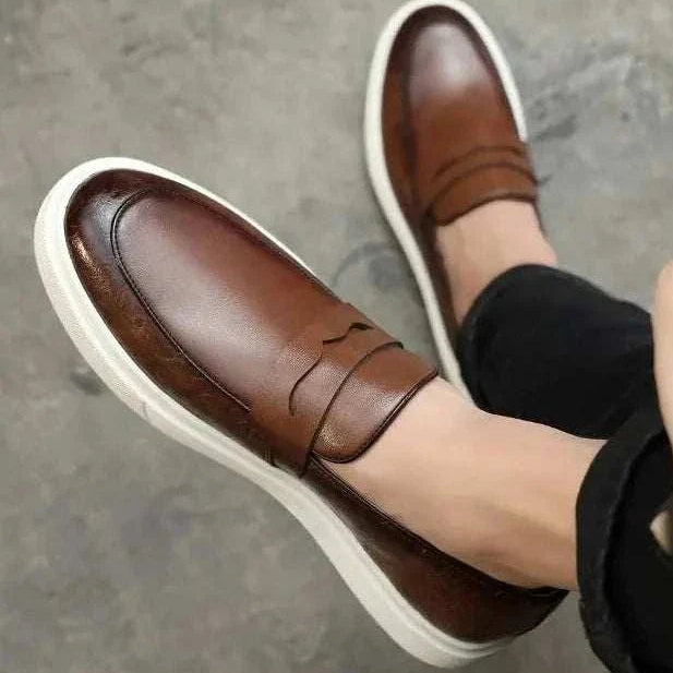 Brown British style casual loafers for men with perforated design.