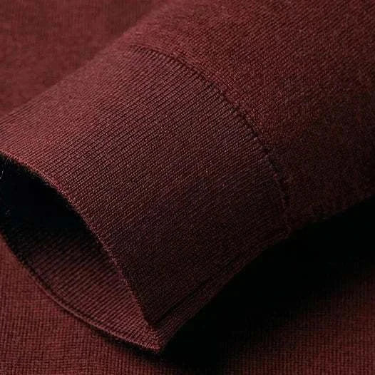 Close-up of sleeve on slim fit wool autumn sweater, showcasing texture and knit quality.