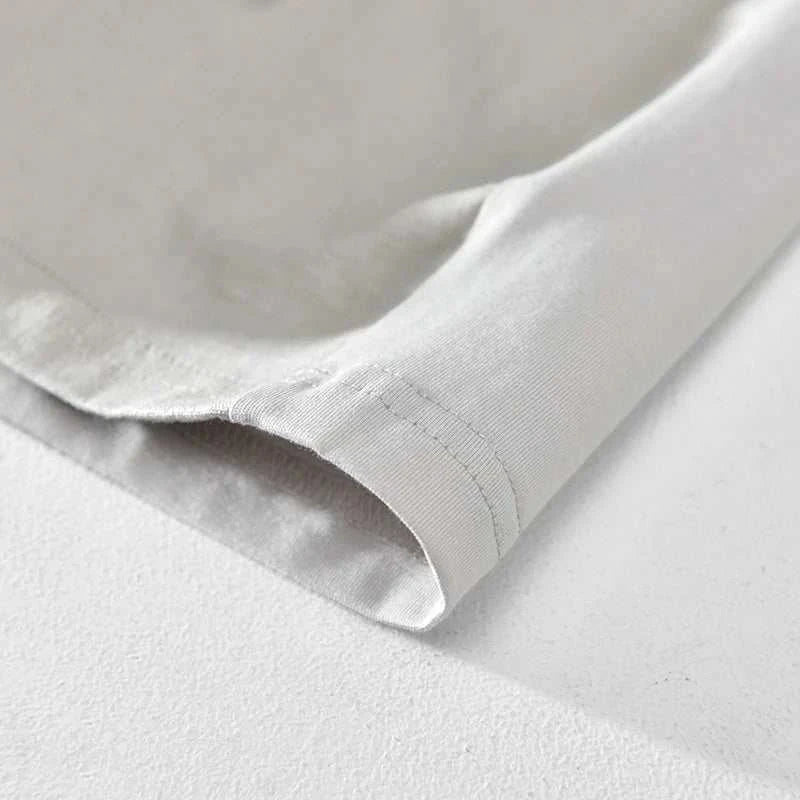 Close-up of hem on tree print slim fit summer t-shirt in soft cotton fabric.