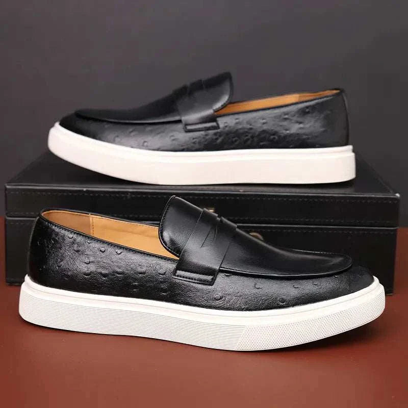 Black LUXELY slip on loafers for men with non-slip rubber outsole, shown on display box.