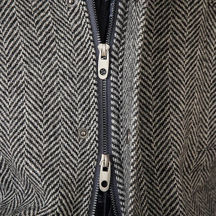 Close-up of wool heavy vintage coat with herringbone pattern and double zipper detail.