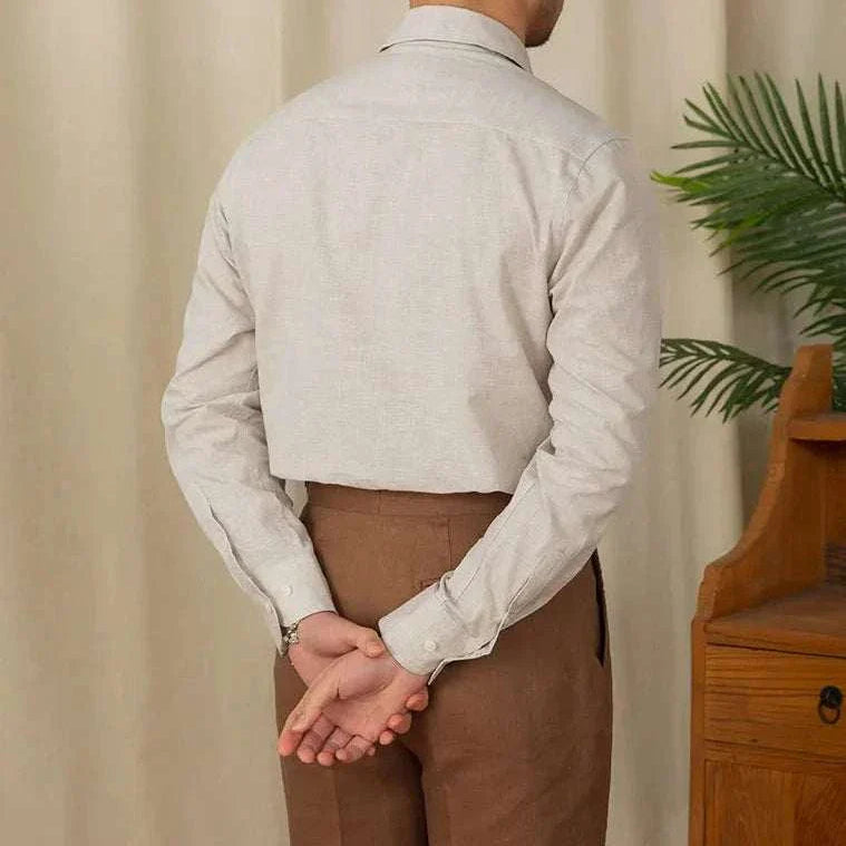 Back view of a man wearing a piece collar casual long-sleeve shirt in linen and cotton blend.
