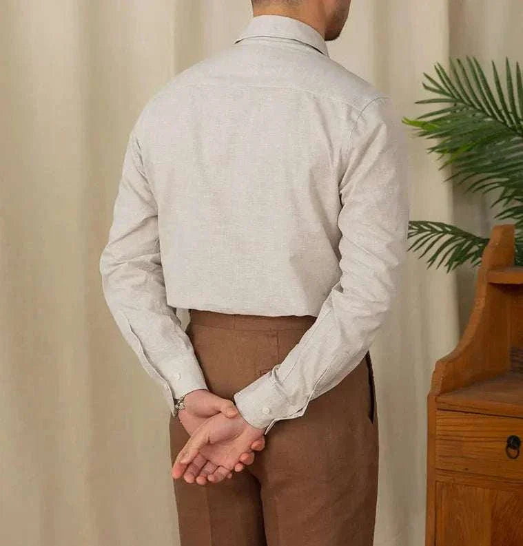 Back view of a man wearing a piece collar casual long-sleeve shirt in linen and cotton blend.