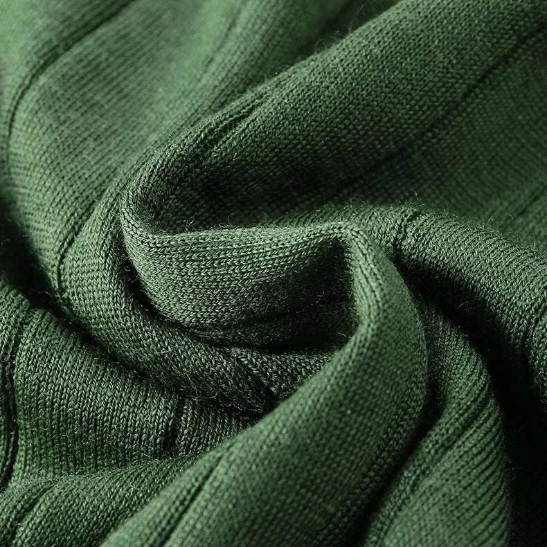 Casual wool autumn sweater fabric detail in dark green color.
