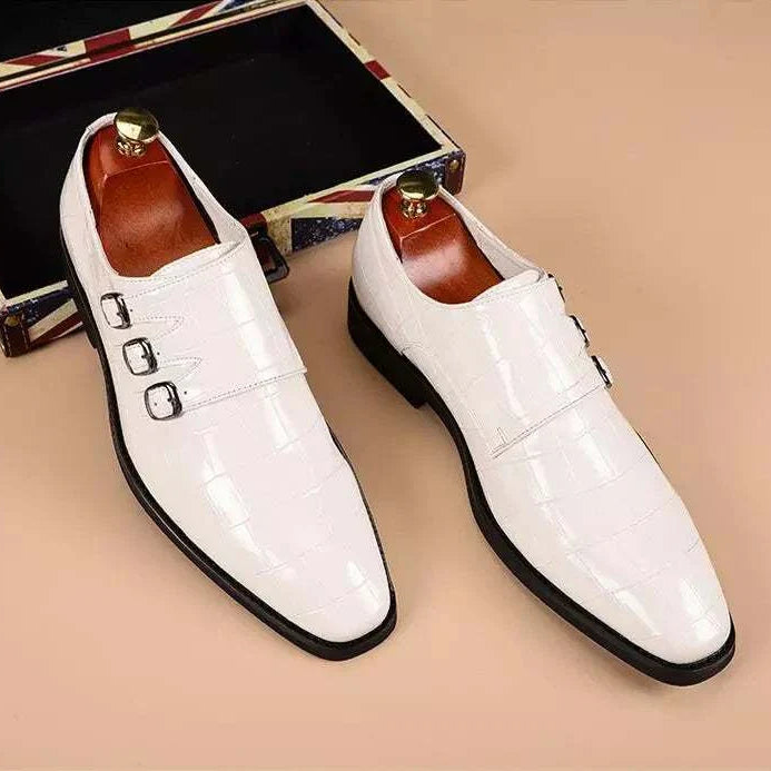 White Oxford triple strip-on shoes with intricate perforations and leather lining.
