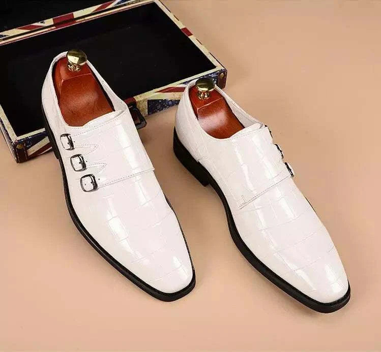 White Oxford triple strip-on shoes with intricate perforations and leather lining.
