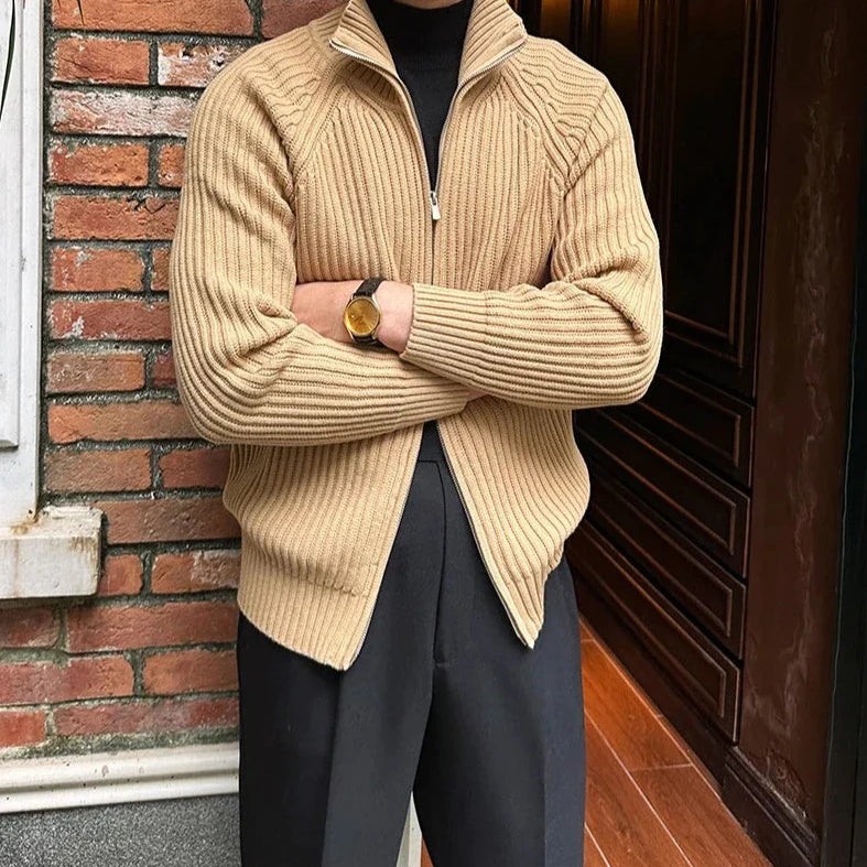 Retro cardigan in khaki, lightweight cotton, worn by man against a brick wall.