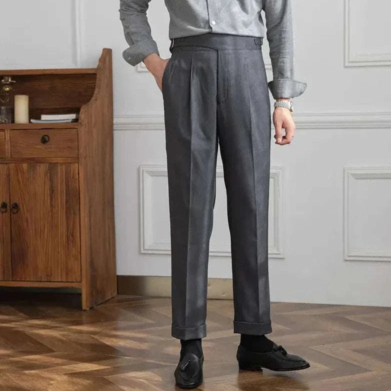 Male model wearing Autumn Italian high-waist trousers in solid gray fabric, styled for a smart casual look.