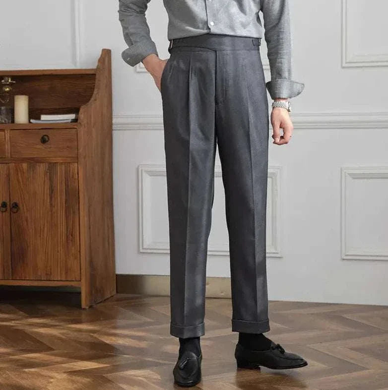 Male model wearing Autumn Italian high-waist trousers in solid gray fabric, styled for a smart casual look.