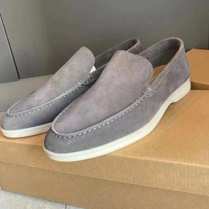 Suede elegant loafers made with soft sheep leather on a box.