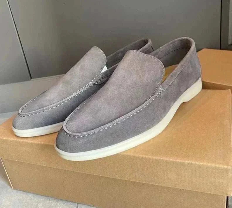 Suede elegant loafers made with soft sheep leather on a box.